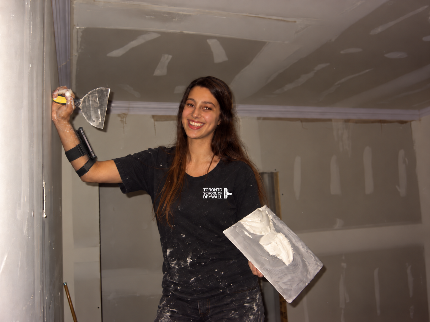 Future of Drywall Skill Development smiling drywall renovator at work